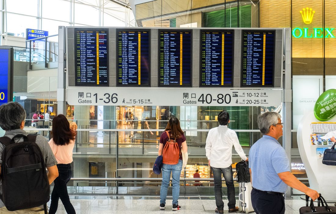 Airport flight information board showing delayed arrivals, tracked airport pick-up