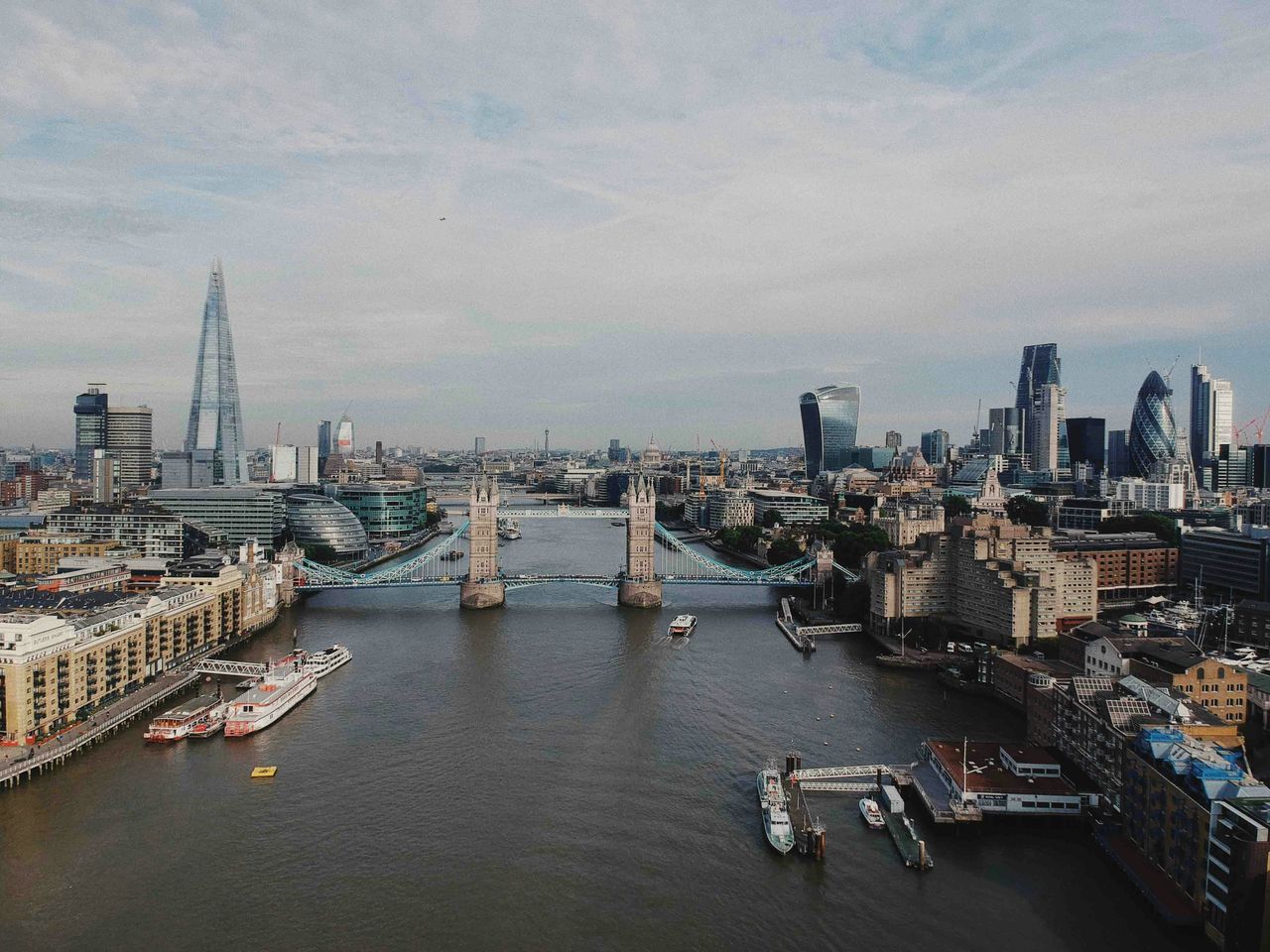 Aerial view of Tower Bridge and the Thames through central London — the postcard berth that only smaller cruise ships can actually reach