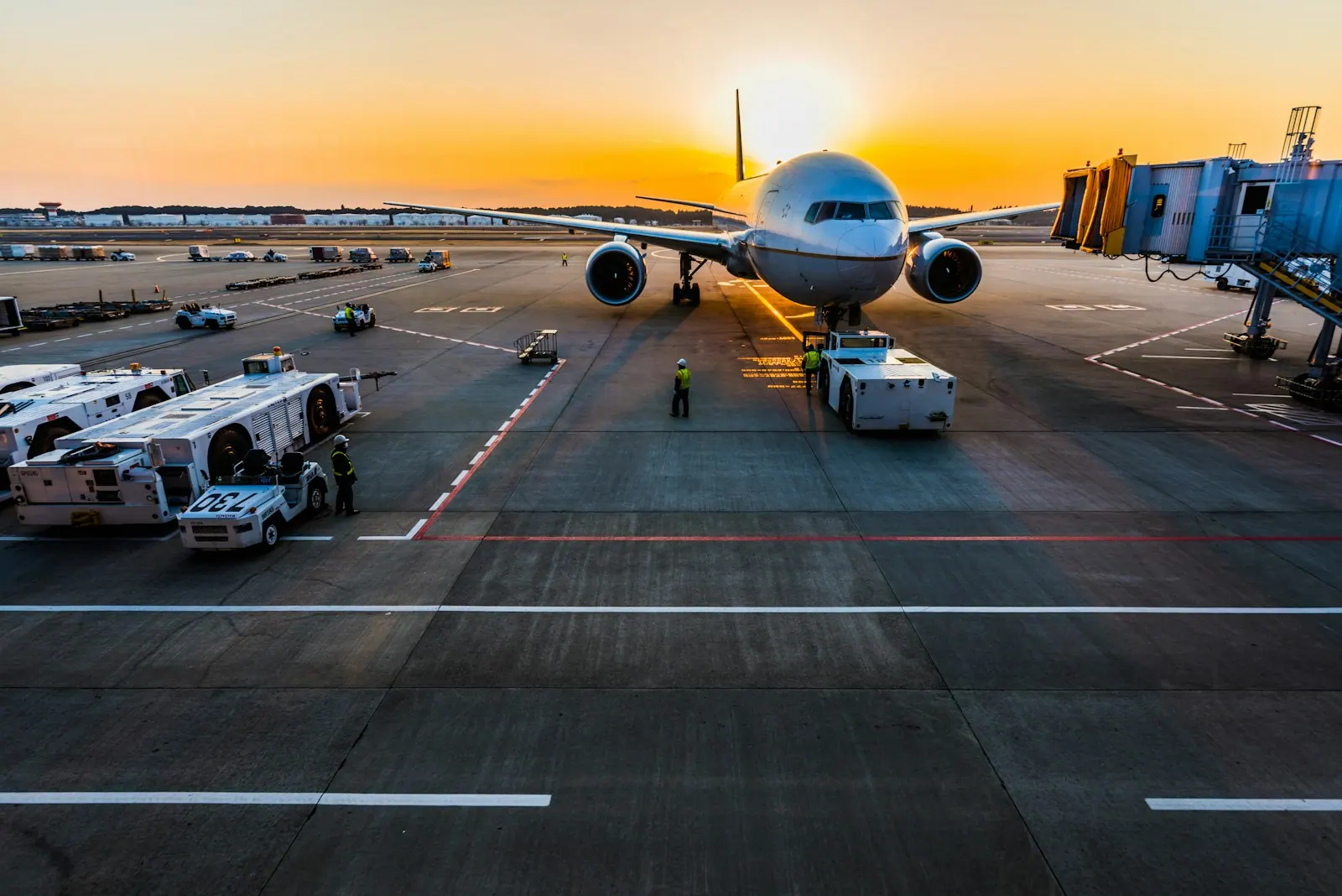 Aircraft at the airport gate at sunset